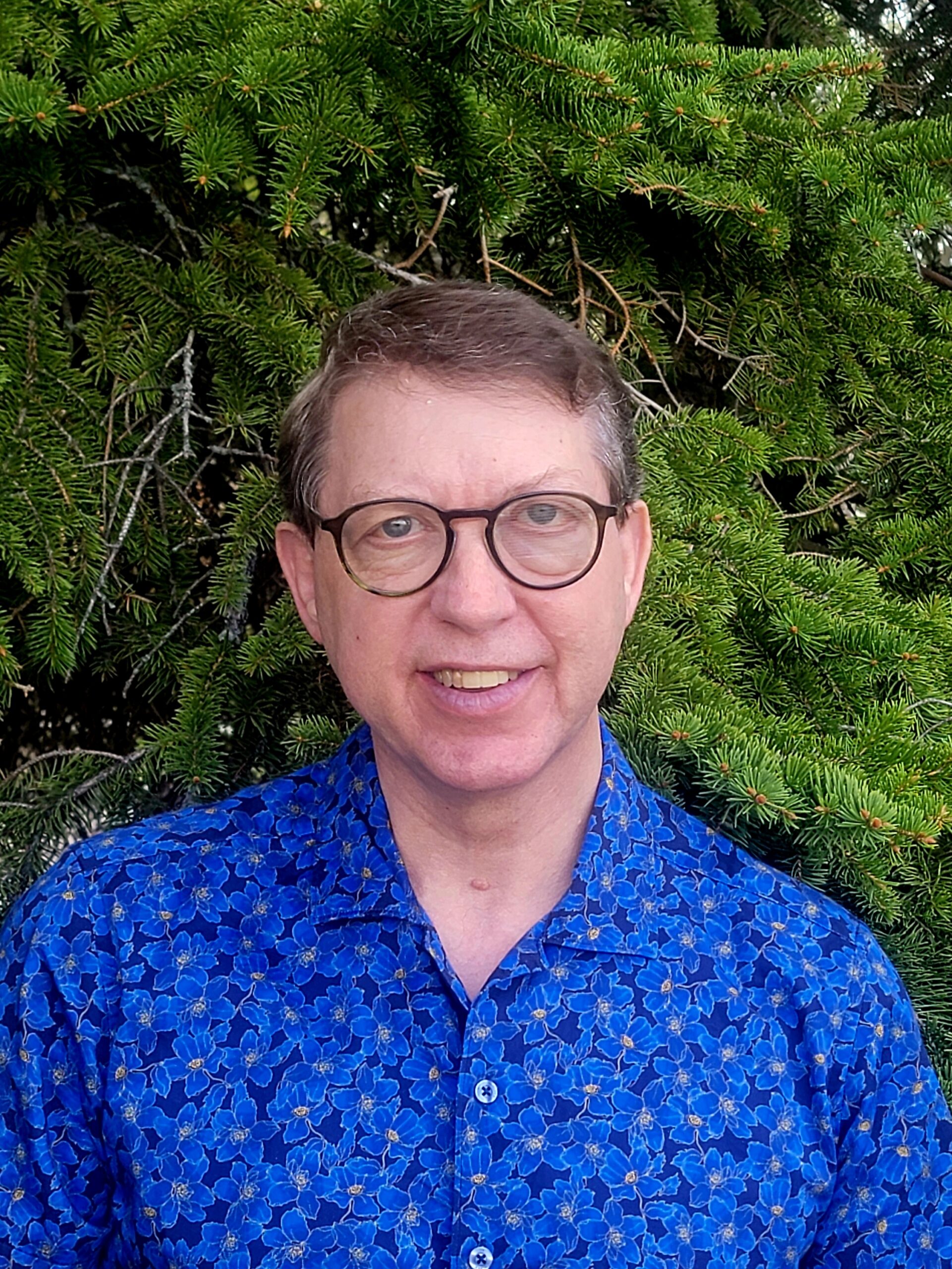 Sam Drew, Registered Clinical Counsellor, smiling warmly in a professional setting